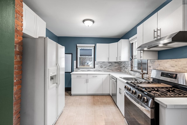 kitchen with stainless steel appliances, white cabinetry, sink, and decorative backsplash