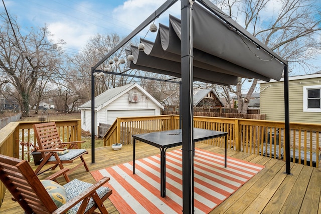 wooden deck with a garage and an outbuilding