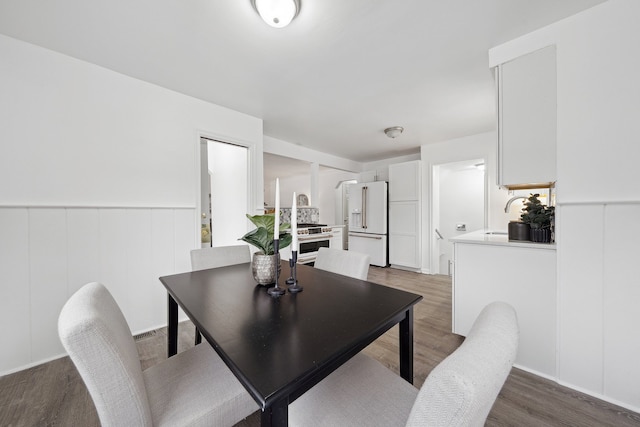 dining area featuring dark hardwood / wood-style floors and sink