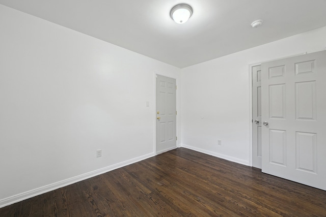 unfurnished room featuring dark hardwood / wood-style floors