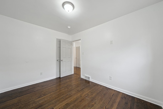 spare room with dark hardwood / wood-style flooring