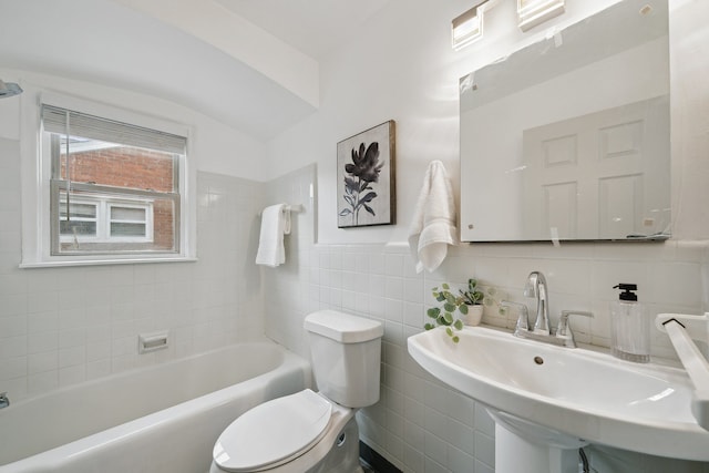 bathroom with toilet, sink, tile walls, and a tub