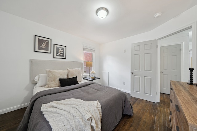 bedroom with dark hardwood / wood-style flooring