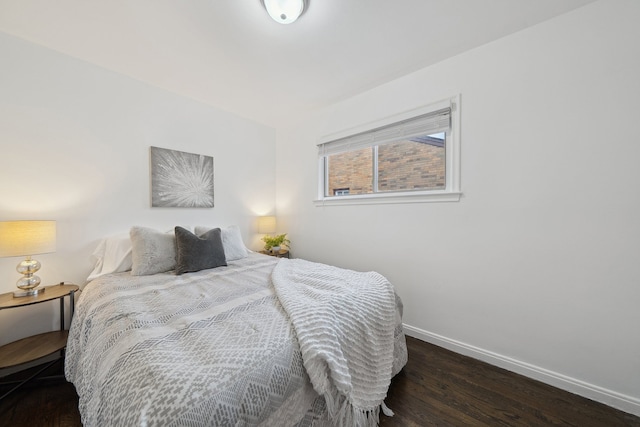 bedroom with dark hardwood / wood-style flooring