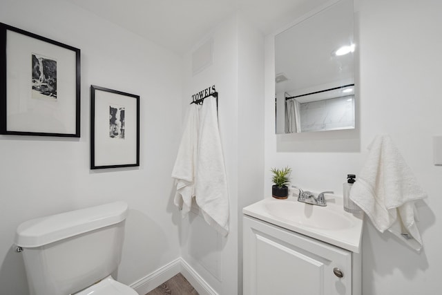 bathroom featuring vanity and toilet