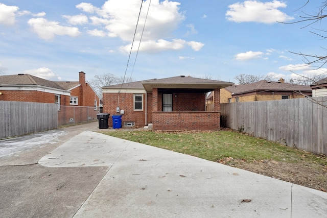 rear view of house with a yard and a patio