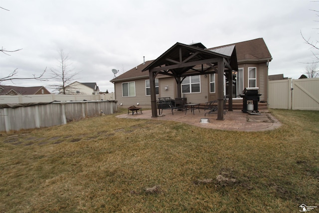 back of property featuring a gazebo, a yard, and a patio area