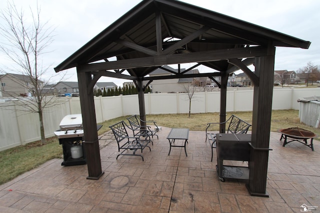 view of patio / terrace with a gazebo, grilling area, and a fire pit