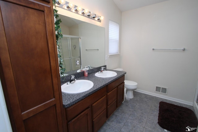 bathroom with vanity, toilet, an enclosed shower, and tile patterned flooring