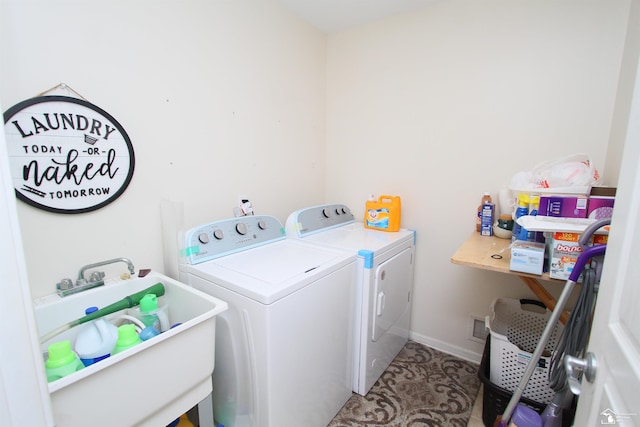 clothes washing area with light tile patterned flooring, sink, and washing machine and clothes dryer