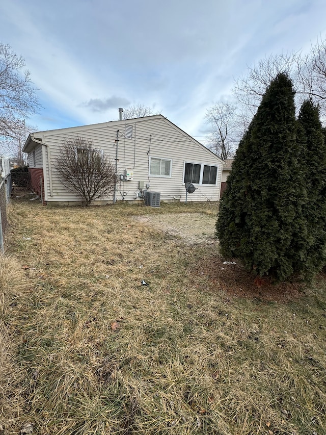 view of home's exterior featuring central AC unit and a lawn