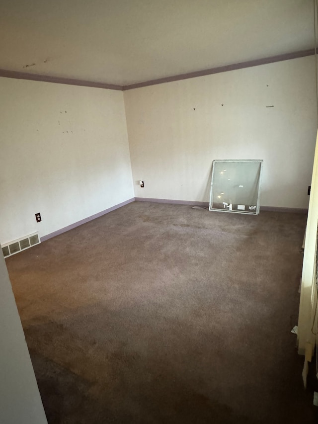 carpeted spare room with crown molding