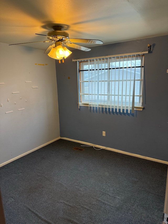 carpeted empty room with a wealth of natural light and ceiling fan