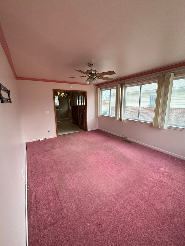 unfurnished room with crown molding, carpet, and ceiling fan