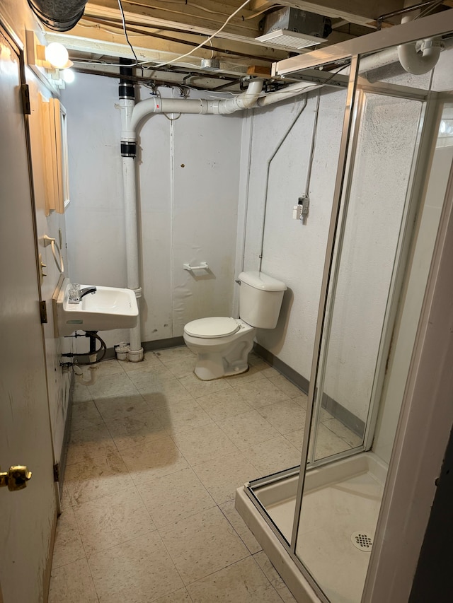 bathroom with toilet, sink, and walk in shower