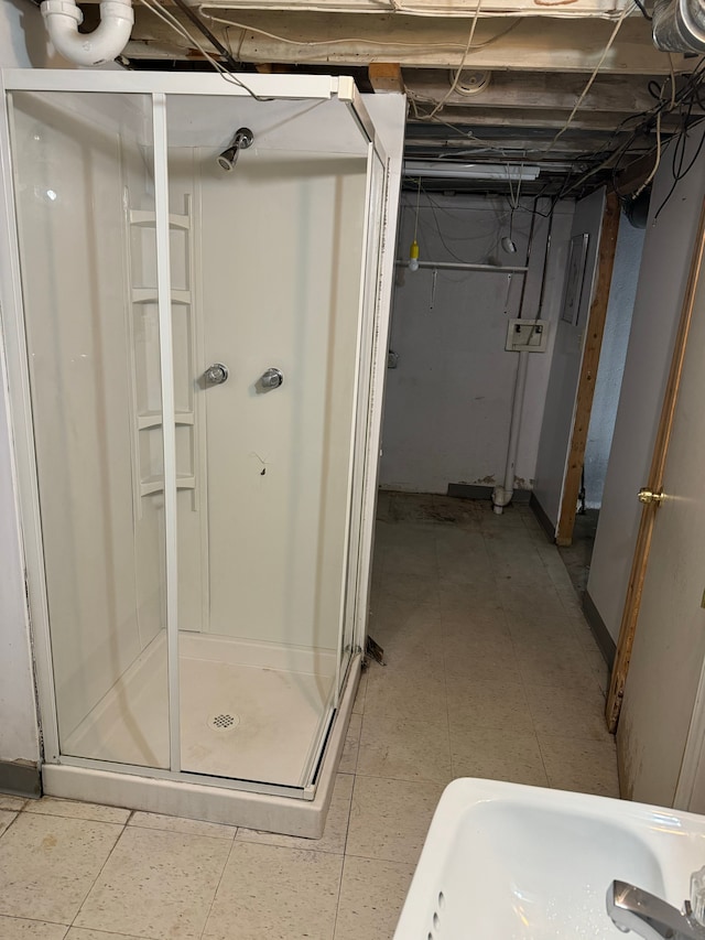 bathroom with sink, a shower with shower door, and tile patterned flooring