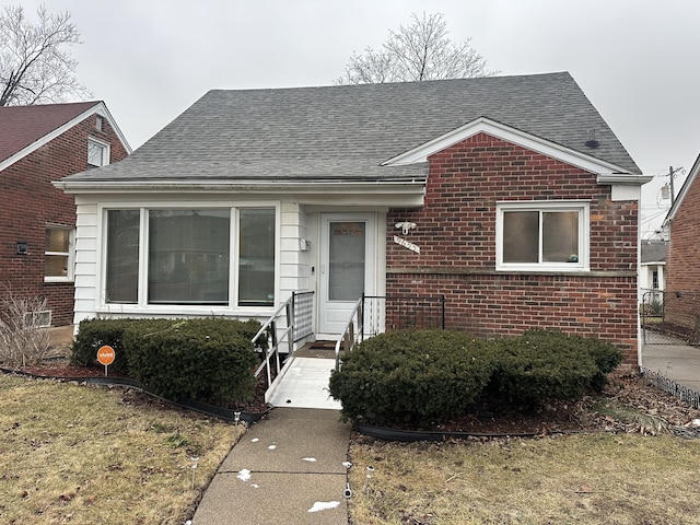 bungalow-style home with a front lawn