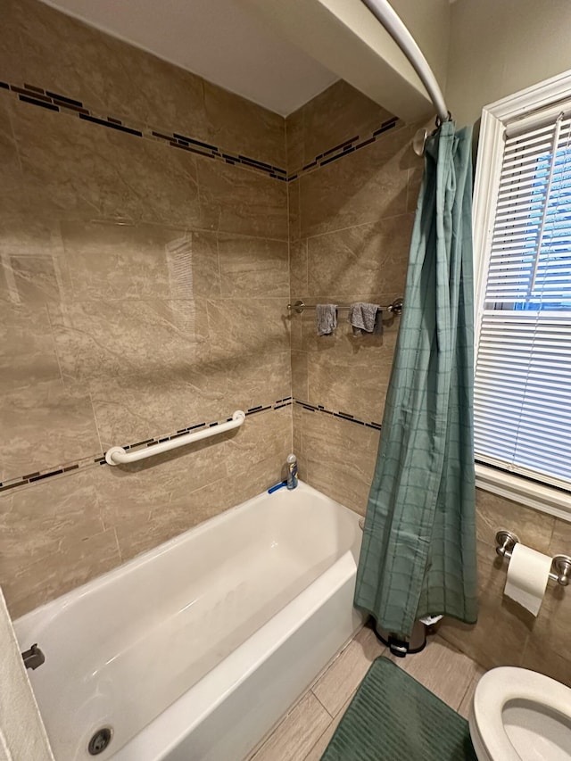 bathroom with toilet and shower / bathtub combination with curtain