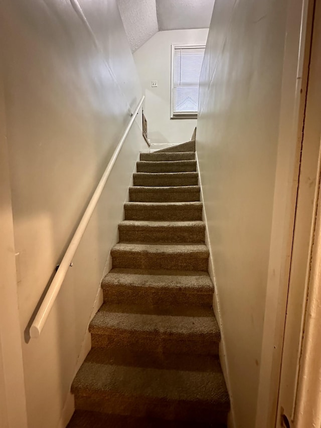 stairs with vaulted ceiling