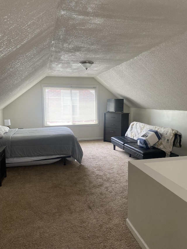 bedroom with vaulted ceiling, a textured ceiling, and carpet