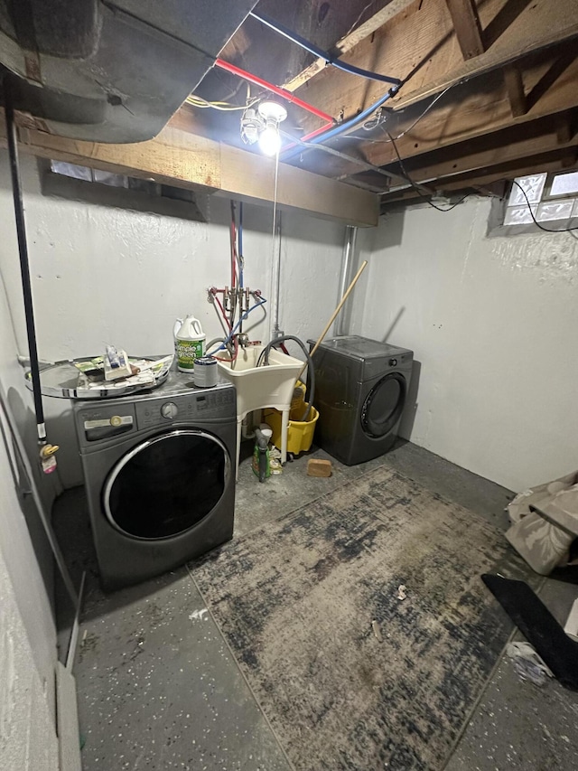 washroom with sink and washing machine and clothes dryer