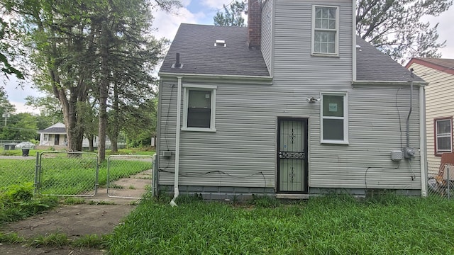 rear view of house featuring a yard