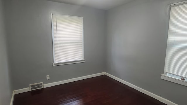 empty room with dark hardwood / wood-style floors