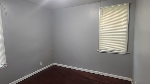 spare room with dark hardwood / wood-style flooring