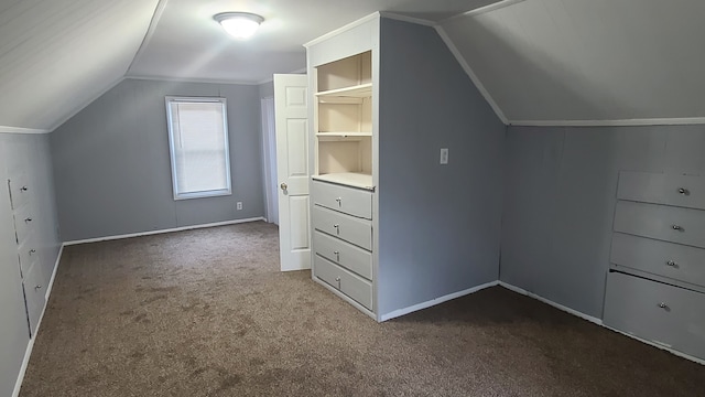 bonus room with vaulted ceiling and carpet flooring