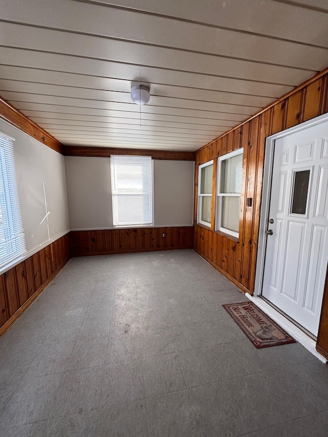 empty room featuring wooden walls