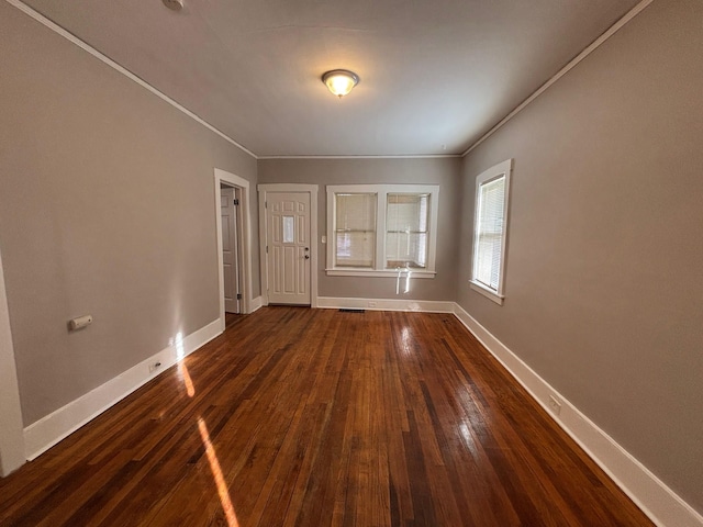 foyer entrance with dark wood-type flooring and ornamental molding