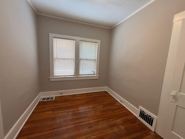 empty room with crown molding and dark hardwood / wood-style floors