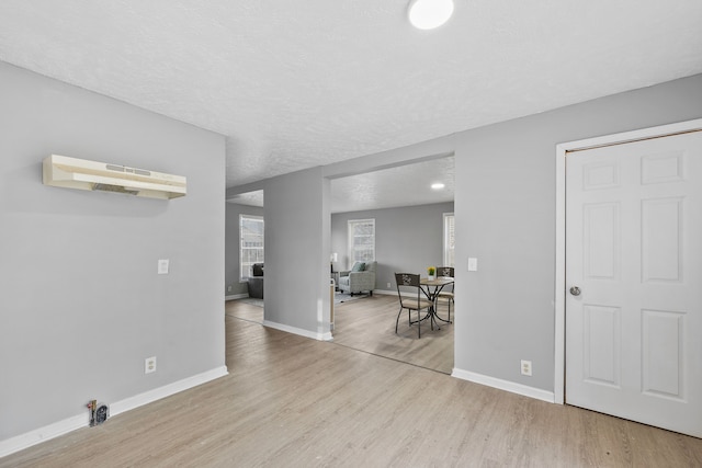 interior space featuring a textured ceiling and light wood-type flooring