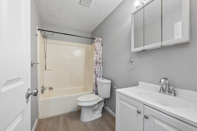 full bathroom with wood-type flooring, shower / bath combination with curtain, vanity, toilet, and a textured ceiling