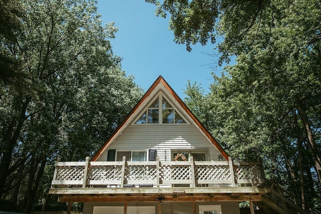 rear view of house featuring a deck