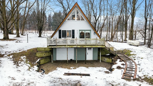 snow covered house with a garage