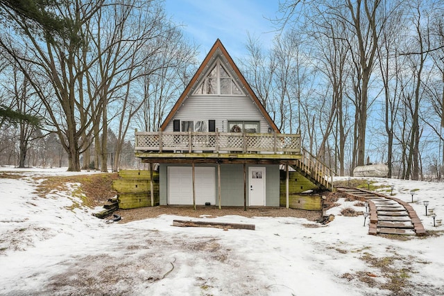 exterior space featuring a wooden deck and a garage