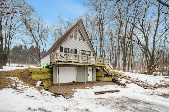 view of front of property with a garage and a deck