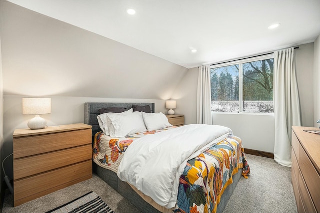 carpeted bedroom with lofted ceiling