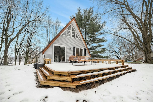 view of snow covered back of property