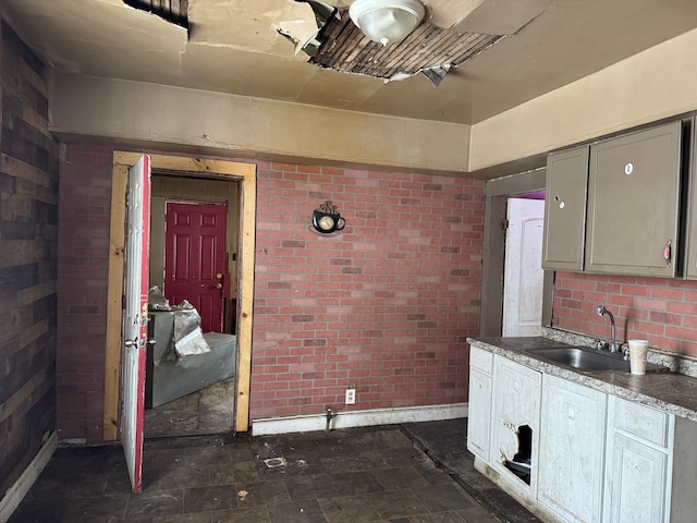 kitchen with brick wall and sink