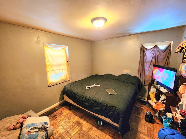 bedroom featuring parquet flooring