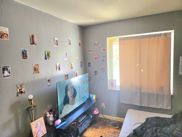 bedroom featuring parquet flooring