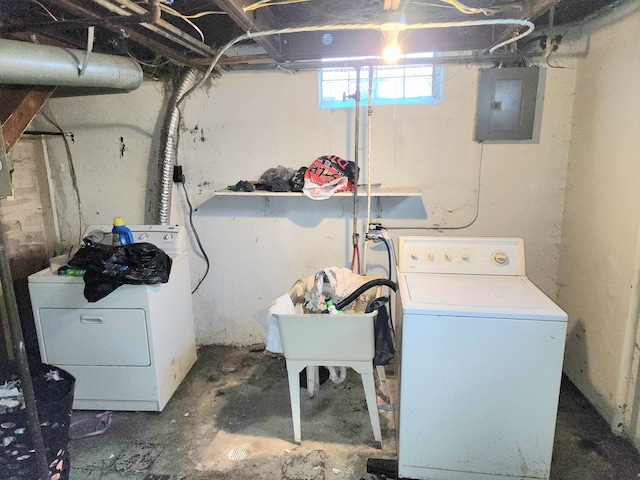 laundry room featuring electric panel and washer and dryer