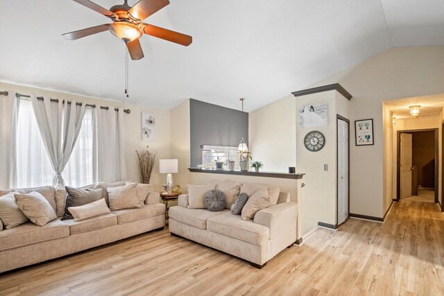 living room featuring light hardwood / wood-style flooring, vaulted ceiling, and ceiling fan