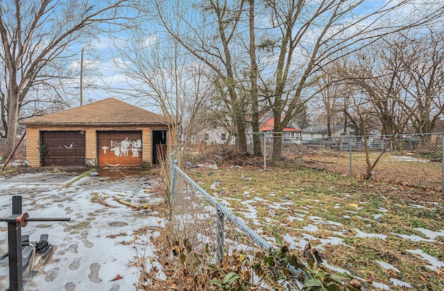1003 Lavette Ave, Benton Harbor, MI 49022 - yard covered in snow with a garage and an outbuilding