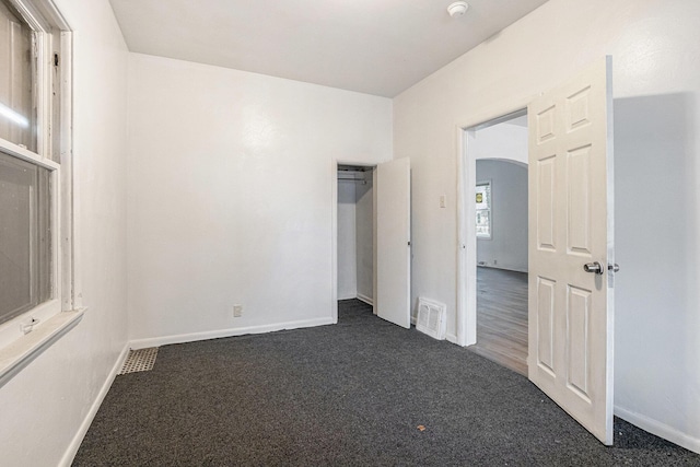 1003 Lavette Ave, Benton Harbor, MI 49022 - unfurnished bedroom featuring dark carpet