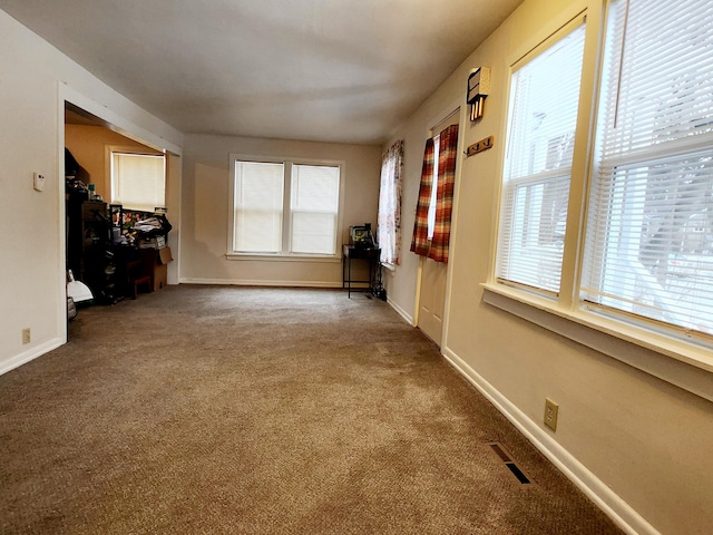 unfurnished living room featuring carpet floors