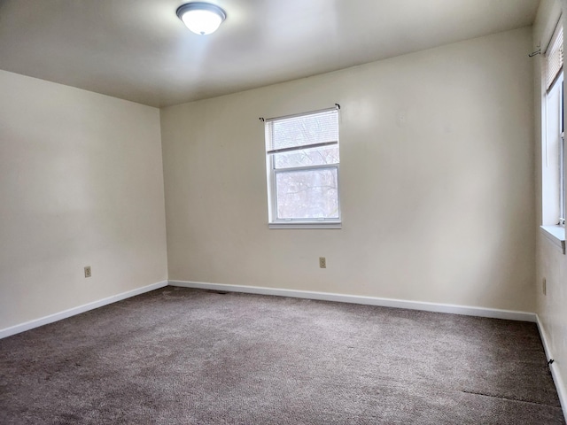 unfurnished room featuring carpet