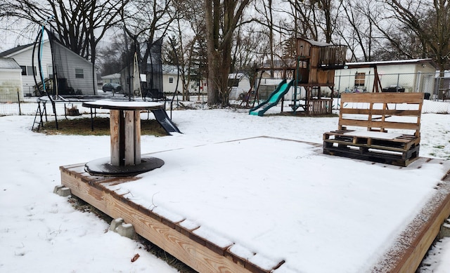 exterior space with a trampoline and a playground